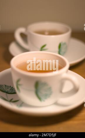 Two cups of tea on a wooden table. Morning light. Stock Photo