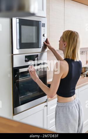 https://l450v.alamy.com/450v/2m7d83f/woman-heating-food-in-microwave-2m7d83f.jpg