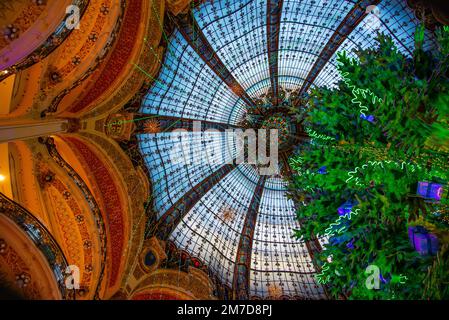 Paris, France - Dec. 26 2022: The beautiful decorated glass ceiling of Lafayette Gallary Stock Photo