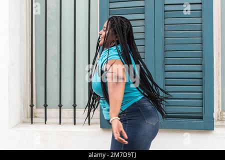 Beautiful fashionable woman with braids dancing break Stock Photo - Alamy