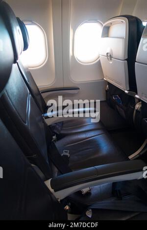 Empty seat / row of vacant seats on Airbus A319 / A320 plane / airplane / aeroplane cabin during a flight. Aircraft was 50% full so at half capacity. Stock Photo