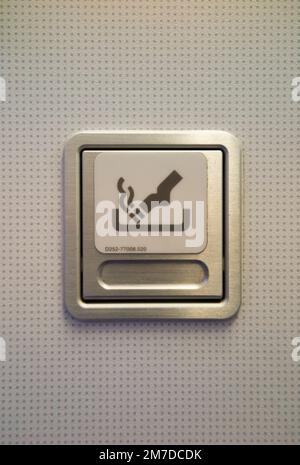 Ash tray / ashtray and No Smoking sign in toilet / loo / lavatory / WC in an Airbus A321 plane / aeroplane / airplane / aircraft. (133) Stock Photo