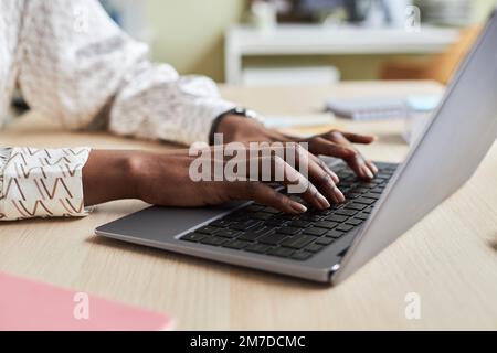 Close up of unrecognizable black young woman using laptop and typing on keyboard Stock Photo