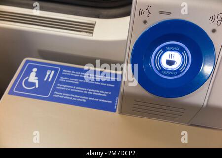 Call button for disabled passenger, or wheel chair user passengers, to communicate with catering and buffet staff on a Swiss train in Geneva, Switzerland. Indicates consideration for vulnerable people. (133) Stock Photo