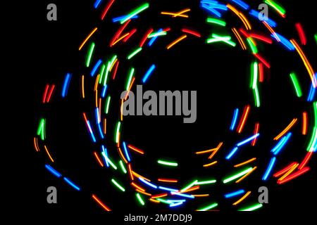 Abstract swirls and patterns of light caused by a spining multicoloured light. Stock Photo
