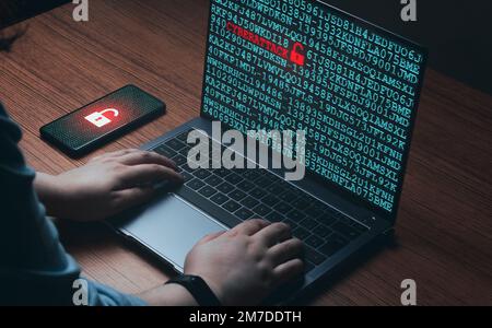 Woman using laptop on wood desk with cyberattack warning on screen. Cyber security concept. Future technology. Hacker. Stock Photo