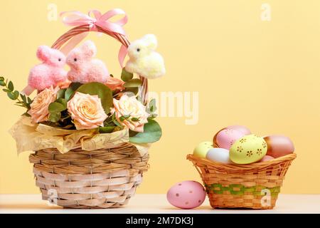 Easter composition still life. Baskets with roses and eggs on the table. Stock Photo