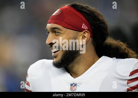 San Francisco 49ers safety Talanoa Hufanga, left, poses for photos with  former 49ers player Jesse Sapolu, middle, while exchanging jerseys with  Miami Dolphins quarterback Tua Tagovailoa, right, after an NFL football game