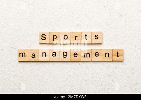 sports management word written on wood block. sports management text on cement table for your desing, concept. Stock Photo
