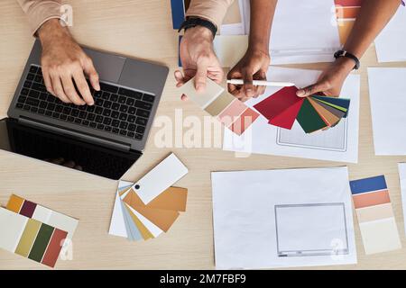 Top view at two designers choosing color swatches while working on UI project in office Stock Photo