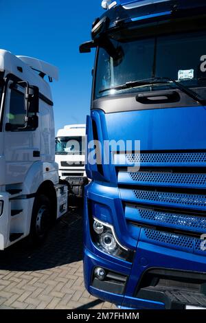 Fleet of white semi trucks in a row  Stock Photo