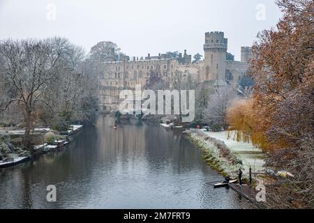 The river Avon as it passes below Warwick castle in the Warwickshire town of Warwick,after a light winter snow fall Stock Photo