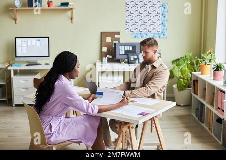 Portrait of two UX designers working together in minimal office setting, copy space Stock Photo