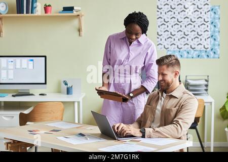 Portrait of two UX designers working together in cozy office setting and smiling, copy space Stock Photo