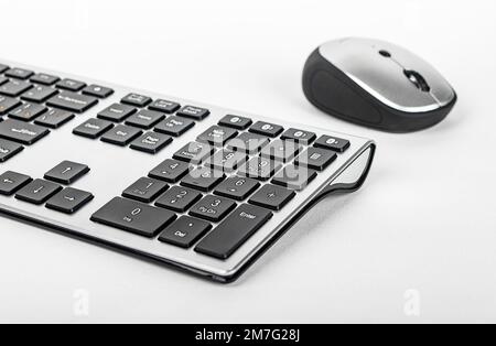 Keyboard and computer mouse of black and silver colors. Modern input devices, bluetooth wireless gadgets for PC. High quality photo Stock Photo