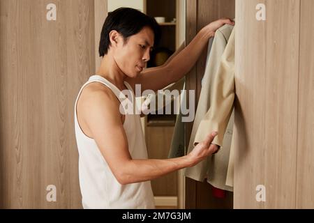 Man getting ready in the morning and choosing suit for meeting Stock Photo
