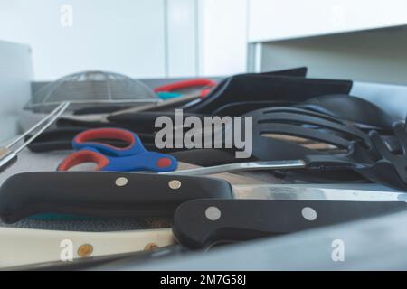 High angle view of a kitchen drawer full of utensils. Concept of minimalism, tidying and cleaning. Stock Photo