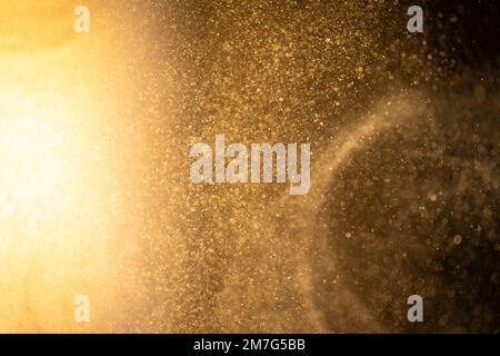 Gold dust particles abstract Bokeh star particle on Black Background. Futuristic dots in space. Stock Photo