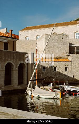 Amazing view of Dubrovnik and the boat in a marina on a sunny day. Travel destination in Croatia. Stock Photo