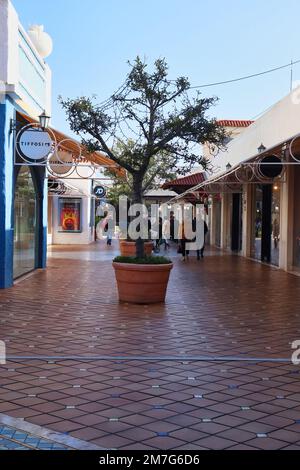 Faro, Portugal - December 22, 2019: Tree in a pot at a shopping center in Faro, Portugal on a warm winter day. Stock Photo