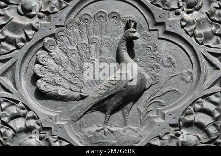 Cast iron relief of a peacock Stock Photo