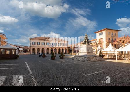 Peveragno, Cuneo, Italy - January 09, 2023: piazza Pietro Toselli with the town hall in neoclassical style and the monument to Major Pietro Toselli Stock Photo