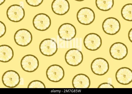 Pattern made of backlit lemon slices on yellow background Stock Photo