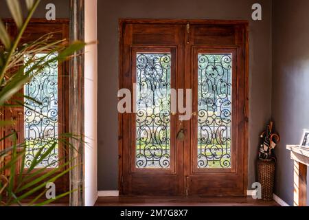 View of a trendy wooden front door from the inside Stock Photo