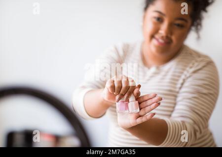 Closeup of cheerful chubby woman streaming from home. Blogging concept Stock Photo