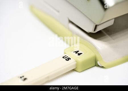 Hole puncher for paper sheets of size DIN A4 Stock Photo