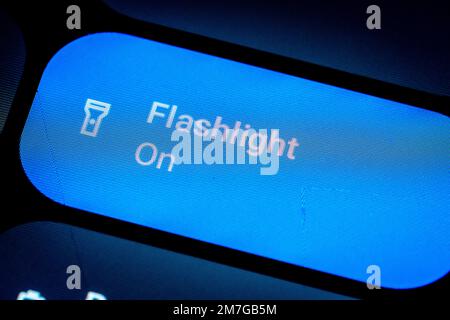 Active button to enable the flashlight of a smartphone Stock Photo
