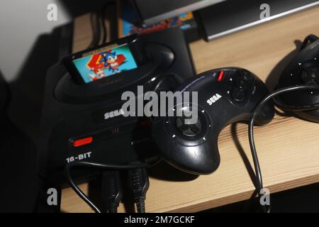 Two Sega Game Gear video game units - the original 1990 release and the  Majesco version from 2001 - on a bed of cartridges Stock Photo - Alamy