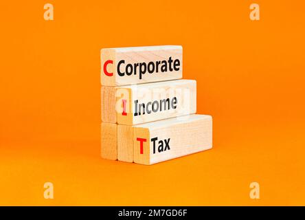 CIT corporate income tax symbol. Concept words CIT corporate income tax on wooden blocks on a beautiful orange table orange background. Business and C Stock Photo