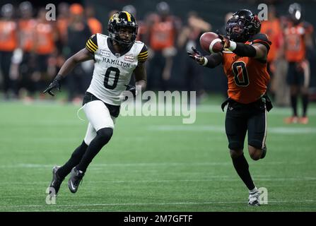 BC Lions' Justin McInnis (18) is tackled by Hamilton Tiger-Cats