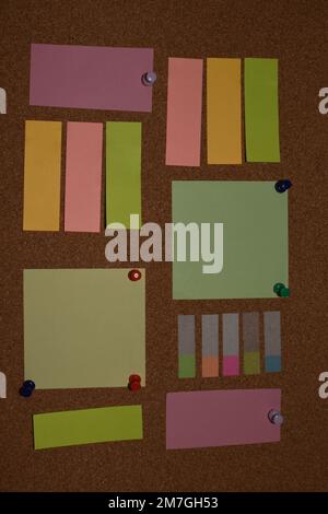 Blank sticky notes with pins on pinboard Stock Photo