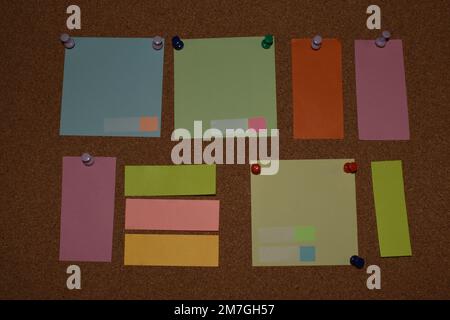 Blank sticky notes with pins on pinboard Stock Photo