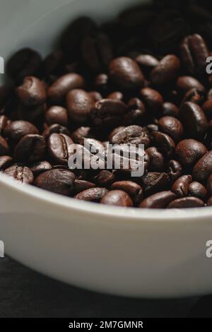 close up of coffee beans in a white bowl Stock Photo