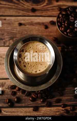 South Indian filter coffee served in steel cup and saucer, selective focus Stock Photo