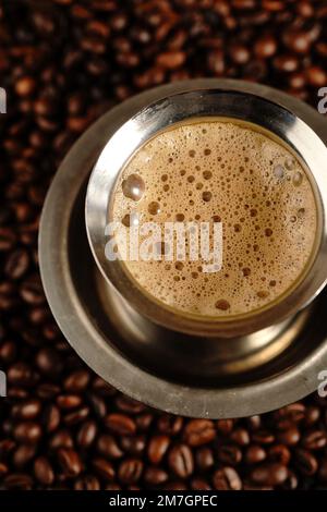 South Indian filter coffee served in steel cup and saucer, selective focus Stock Photo