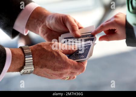 A Magician pictured doing a magic trick on a kid at a wedding in Sussex, UK. Stock Photo