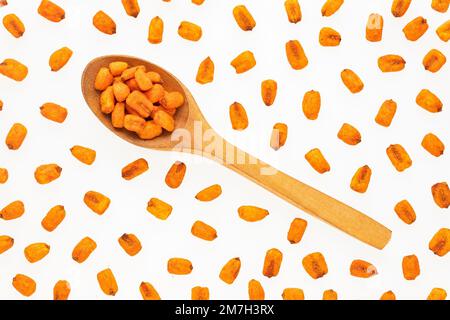 Crunchy salty chili corn - Zea mays. Toasted snacks on the spoon Stock Photo