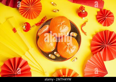 Mandarins with Chinese symbols on yellow background, closeup Stock ...
