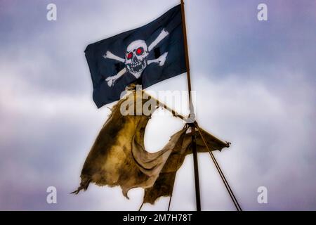 Tattered Sail And Pirate Flag Stock Photo