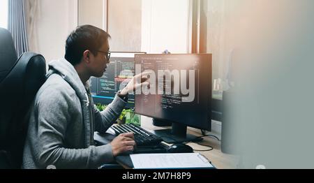 Coder programmers working in office, Programmer analyst writing code - Coder working from home with work on screen computer for learning and developin Stock Photo