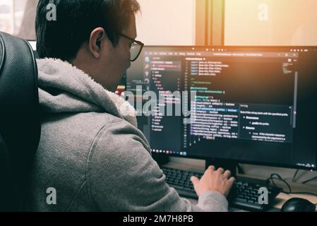 Coder programmers working in office, Programmer analyst writing code - Coder working from home with work on screen computer for learning and developin Stock Photo