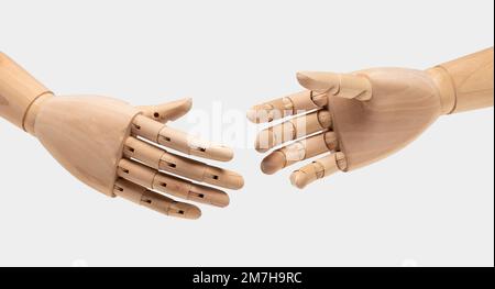 Two wooden mannequin hands on white background. Shaking hands. Business concept. Stock Photo
