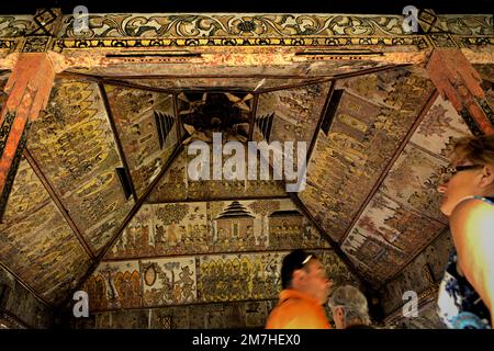 Tourists at Kertha Gosa, an iconic pavilion that its ceiling showcasing ...