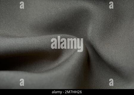 Grey fabric background. Grey cloth waves background texture. Grey fabric cloth textile material. Stock Photo