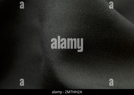 Grey fabric background. Grey cloth waves background texture. Grey fabric cloth textile material. Stock Photo