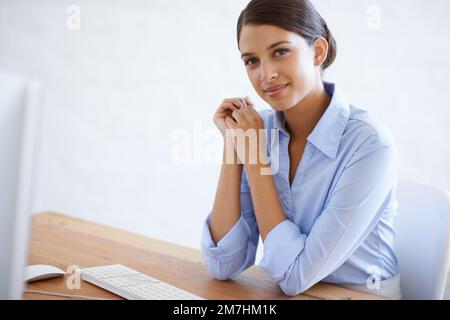 Attractive and successful. Portrait of a beautiful young businesswoman at her office desk. Stock Photo